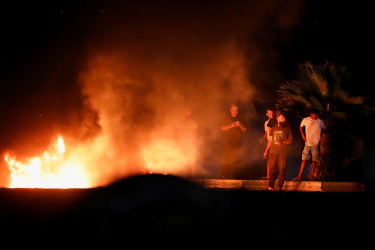 Demonstrators burn tires in protest against the meeting between the foreign affairs ministers of Libya and Israel held last week in Italy, in Tripoli, Libya, August 28, 2023. REUTERS/Hani Amara