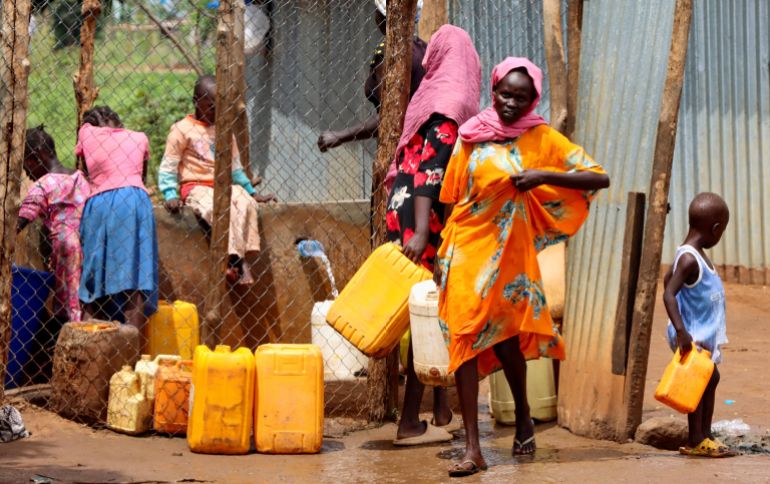 FILE PHOTO: Sudanese refugees collect water from a tap at the Gorom Refugee camp near Juba