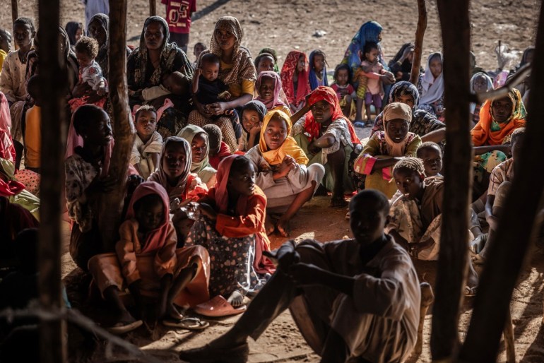 اللاجئون السودانيون والعائلات من جنوب السودان الذين فروا من الحرب في السودان يتجمعون بعد عبور الحدود أثناء انتظار تسجيلهم من قبل السلطات عند معبر جودا الحدودي، بالقرب من الرنك.