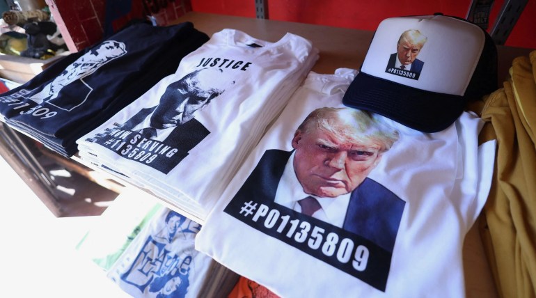 T-shirts and hats with an image depicting the mugshot of former U.S President Donald Trump are pictured after being printed at the Y-Que printing store in Los Angeles