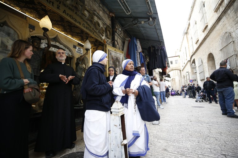 القدس – 29 مارس: المسيحيون القادمون من جميع أنحاء العالم يحملون الصلبان الخشبية يسيرون على طول طريق الآلام (طريق المعاناة) قبل عيد الفصح في البلدة القديمة بالقدس خلال موكب الجمعة العظيمة في 29 مارس 2024. تتخذ الشرطة الإسرائيلية إجراءات أمنية أثناء الموكب. (سعيد قاق - وكالة الأناضول)