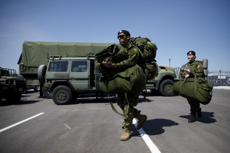 TORONTO, ON - APRIL 06: Members of the Canadian Forces head to their vehicles at Denison Armory to convoy to CFB Borden amid the spread of the coronavirus disease (COVID-19) on April 6, 2020 in Toronto, Canada. Troops will remain ready to respond to any requests made by any levels of government in Canada to help fight the pandemic. Cole Burston/Getty Images/AFP (Photo by Cole Burston / GETTY IMAGES NORTH AMERICA / Getty Images via AFP)