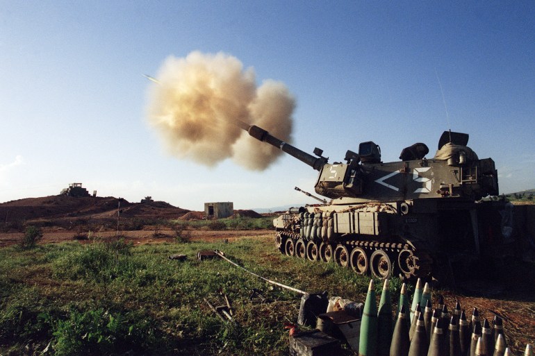 The US-made Israeli M109 self-propelled 155 mm howitzer cannons pound Hezbollah targets in southern Lebanon from an artillery position at he Israeli-Lebanese border 20 April 1996 Many Lebanese civilians were killed during Israel's 