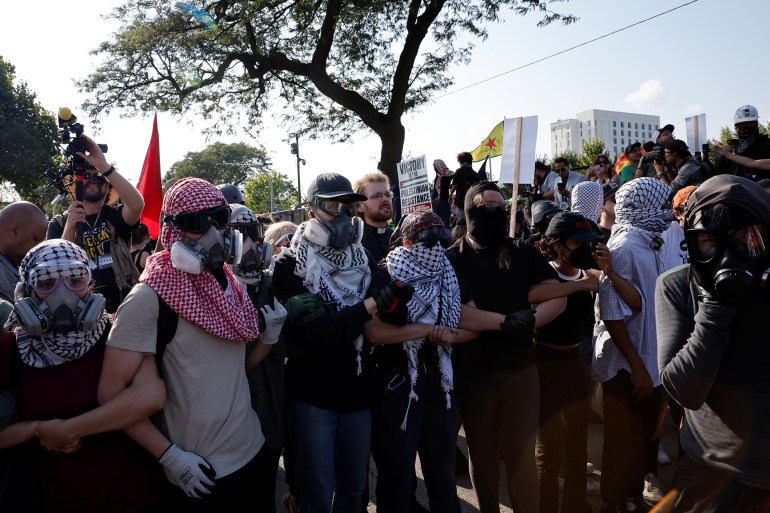 People attend a rally "March on the DNC" on the sidelines of the Democratic National Convention (DNC) in Chicago, Illinois, U.S., August 19, 2024. REUTERS/Marco Bello