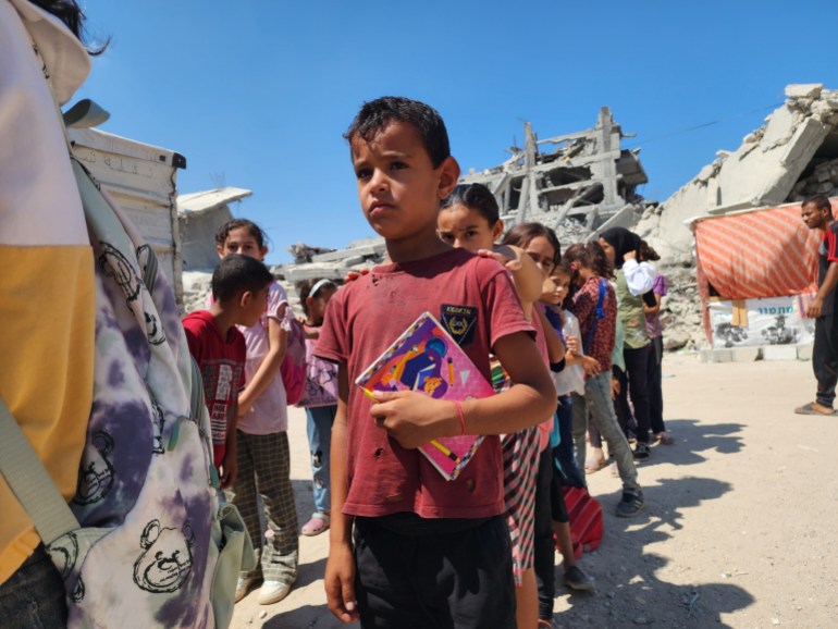 KHAN YUNIS, GAZA - SEPTEMBER 03: Students line up to enter their tent school, in which their teacher Alaa Abu Mustafa, whose house was destroyed in the Israeli army's attacks, gives them education in Khan Yunis, Gaza on September 03, 2024. The tent school was built on the rubble of the destroyed house of the teacher. Despite the limited and difficult conditions, teacher Alaa strives to ensure that primary school students are not deprived of education. (Photo by Hani Alshaer/Anadolu via Getty Images)