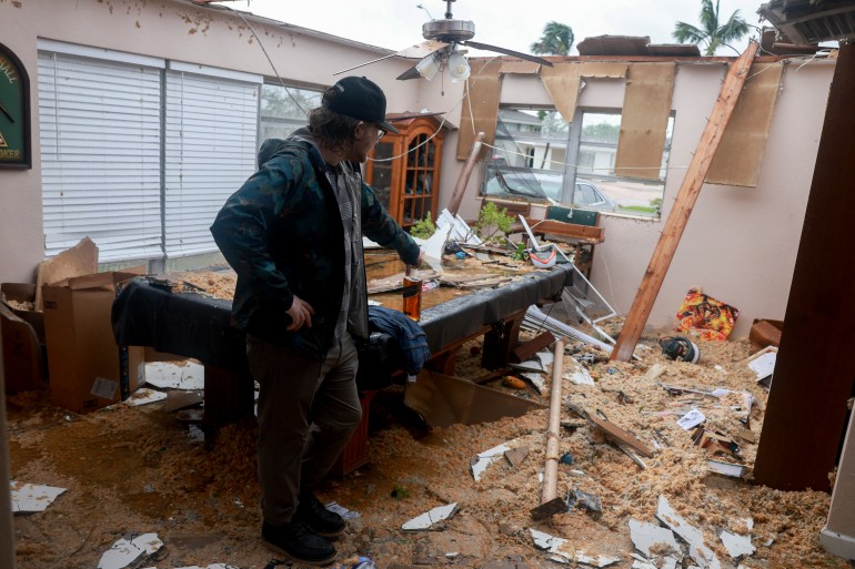 FORT MYERS, FLORIDA - OCTOBER 09: Connor Ferran surveys what is left after what appeared to be a tornado tore the roof off of his home before Hurricane Milton's arrival on October 09, 2024, in Fort Myers, Florida. He said he had just had the roof replaced two years after Hurricane Ian had damaged it. People are preparing for the storm, which could be a Cat 3 when it makes landfall on Wednesday evening. Joe Raedle/Getty Images/AFP (Photo by JOE RAEDLE / GETTY IMAGES NORTH AMERICA / Getty Images via AFP)