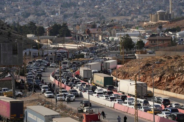 People make their way as they attempt to cross into Lebanon at the Masnaa border crossing between the Lebanon and Syria, after Syrian rebels announced that they have ousted Syria's Bashar al-Assad, as pictured from the Syrian side December 9, 2024. REUTERS/Mohammed Yassin TPX IMAGES OF THE DAY