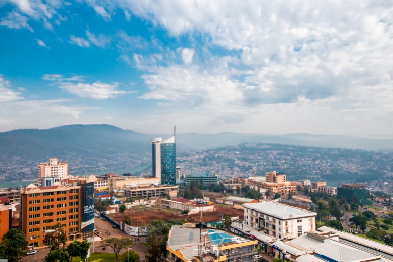 Kigali, Rwanda - September 21, 2018: a wide panoramic view looking down on the city centre with Kigali City Tower against the backdrop of distant hills, under a blue sky with white clouds