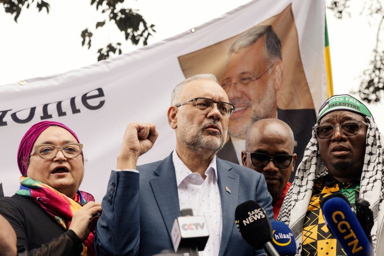 Former South African Ambassador to the United States Ebrahim Rasool (c), addresses supporters upon his arrival at the Cape Town International airport, in Cape Town, on March 23, 2025. Ties between Washington and Pretoria have slumped since Trump cut financial aid to South Africa over its land policy, genocide case against US ally Israel and other foreign policy clashes. US Secretary of State Marco Rubio said last week Rasool was expelled after he described Trump's Make America Great Again movement as a supremacist reaction to diversity in the US. (Photo by GIANLUIGI GUERCIA / AFP)