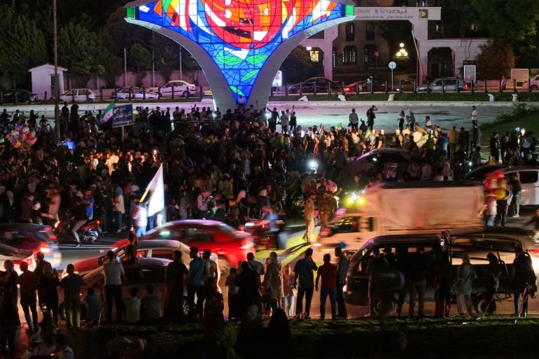 People celebrate in Damascus' Omeyyad square after US President Donald Trump's decision to lift sanctions in Syria, on May 13, 2025.